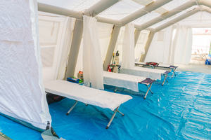 hospital beds in a tent 