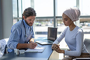 A healthcare professional consulting with a patient