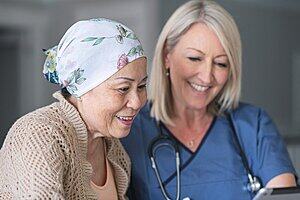 An elderly cancer patient and a medical practitioner