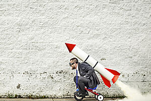 man riding toy rocket