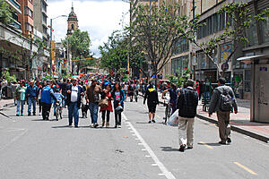 Photograph of street in Bogota with many pedestrians